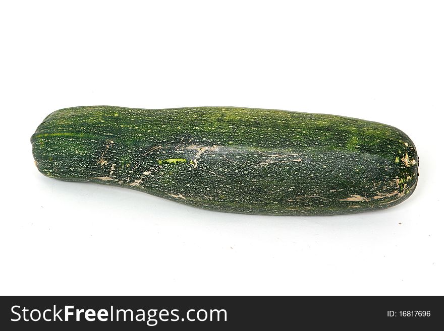 A vegetable marrow on white plate