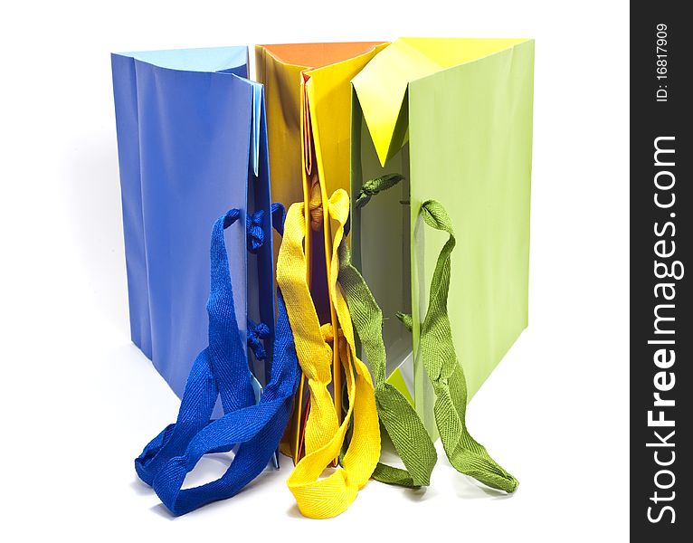 Bags of colored paper on white background