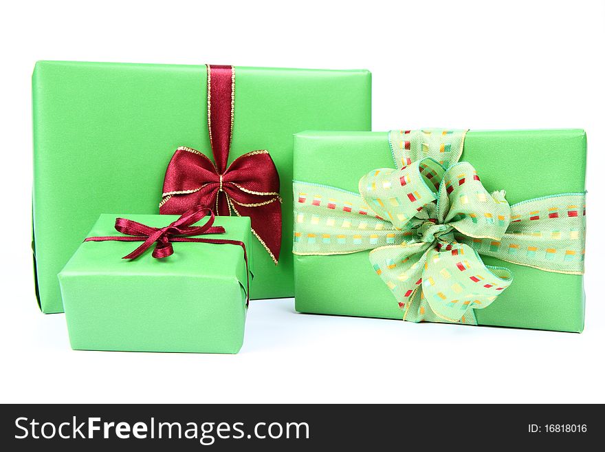 Gifts in green wrapping with bows on white background