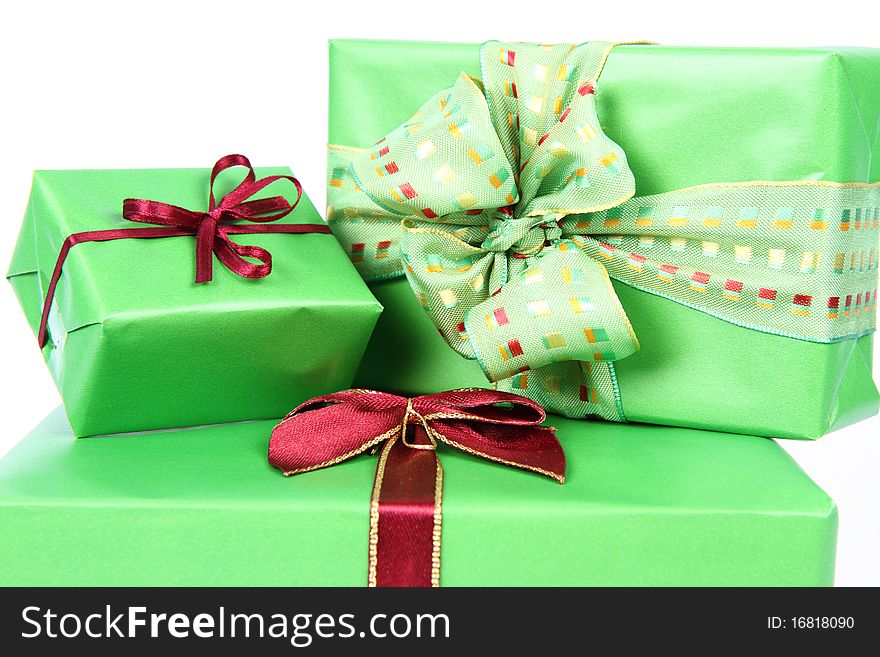 Gifts in green wrapping with bows in close up
