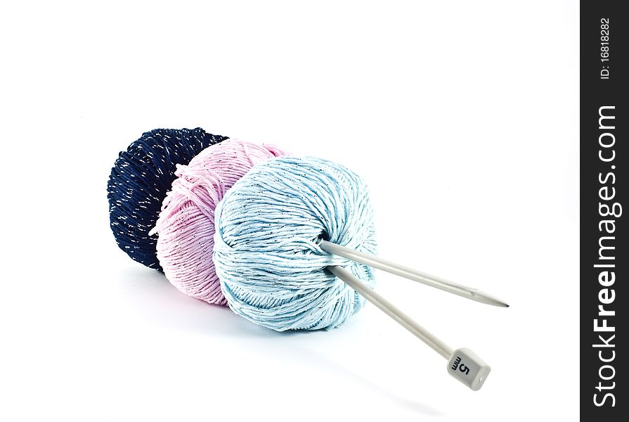 Three cotton balls are for knitting on a white background