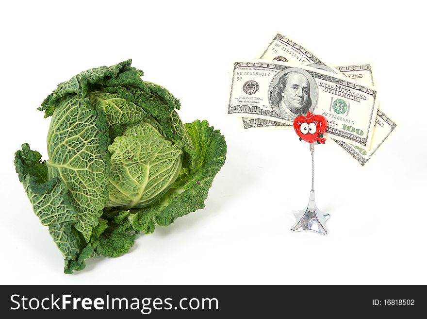 A head of savoy cabbage with three one thundred dollar banknotes on white background. A head of savoy cabbage with three one thundred dollar banknotes on white background