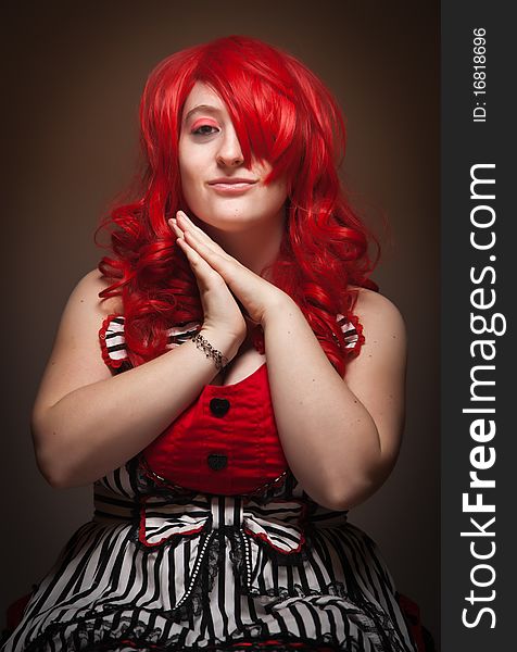 Attractive Red Haired Woman Wearing Bunny Ear Hat on a Grey Background.