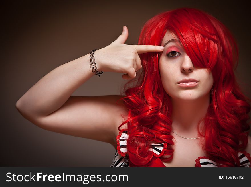 Attractive Red Haired Woman Wearing Bunny Ear Hat on a Grey Background.