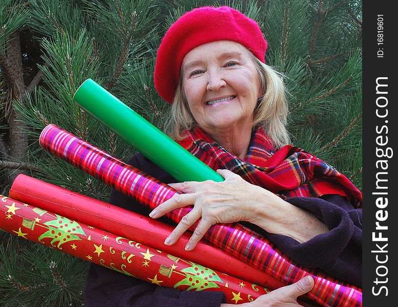 Woman getting her christmas tree and gift wrapping paper in time for christmas. Woman getting her christmas tree and gift wrapping paper in time for christmas.