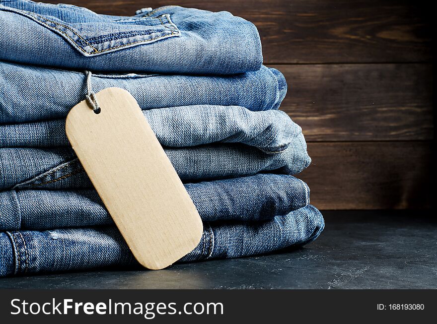 Denim. Blue Jeans On Black Background. Label For Writing Text. Copy Space. The Concept Of Selling Goods In The Store.