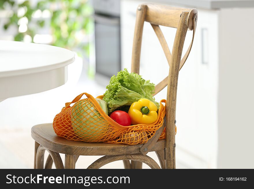 Net Bag With Vegetables On Chair In Kitchen