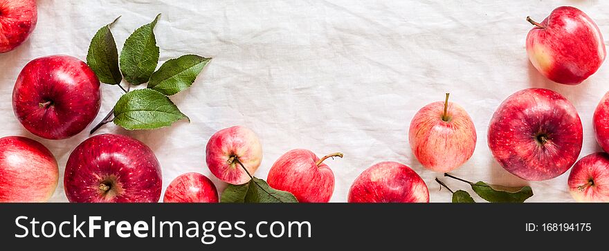 Ripe Red Apples with Leaves, Wrinkled White Cloth Background, banner, copy space for your text. Ripe Red Apples with Leaves, Wrinkled White Cloth Background, banner, copy space for your text