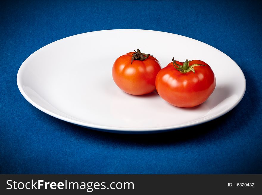 Cut piece of  juice Tomato on bluebackground