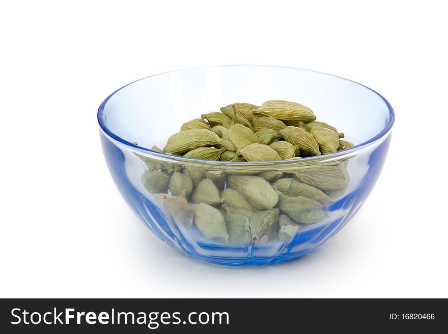 Group of cardamom pads on white background in bowl