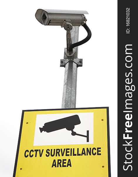 A security camera with a signboard stating CCTV Surveillance Area against a bright background