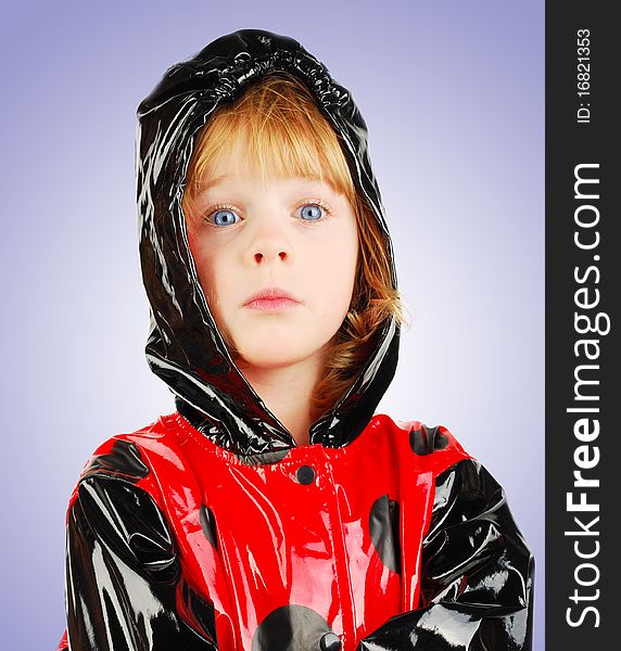 Child With Funny Face  In Rain Coat.