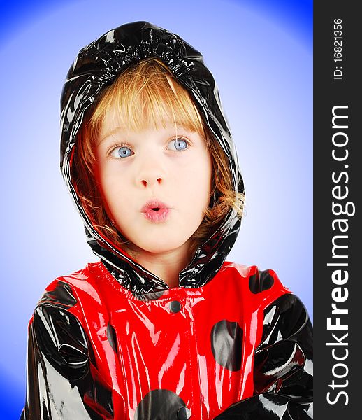 Studio shot with child portrait with red raincoat isolated on the gradient background. Studio shot with child portrait with red raincoat isolated on the gradient background.
