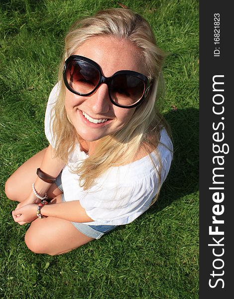 A young lady is enjoying the nice day at the park. A young lady is enjoying the nice day at the park