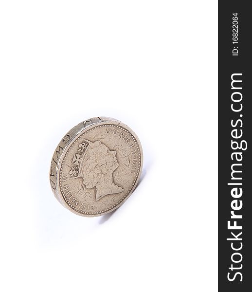 English pound coin stood up against a white background. English pound coin stood up against a white background