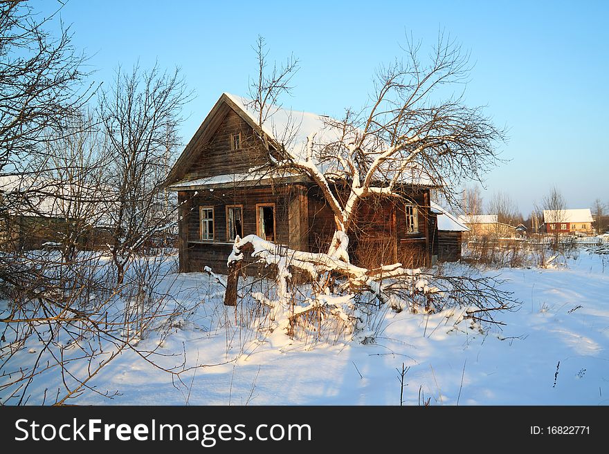 Old rural house in snow