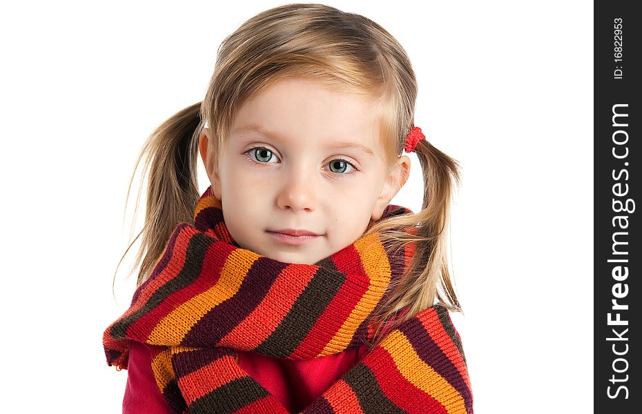 Portrait of a cute little girl in a striped scarf. Portrait of a cute little girl in a striped scarf