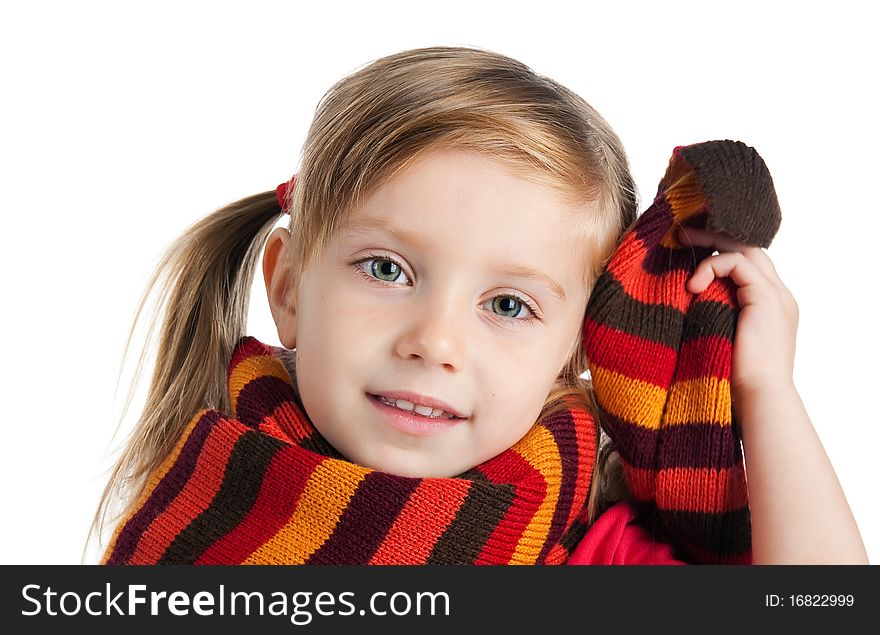 Portrait of a cute little girl in a striped scarf