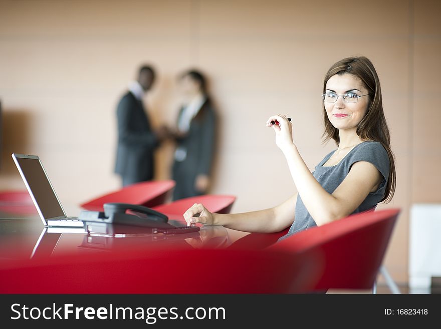 Portrait of a young businesswoman, colleagues on backgrounds. Portrait of a young businesswoman, colleagues on backgrounds