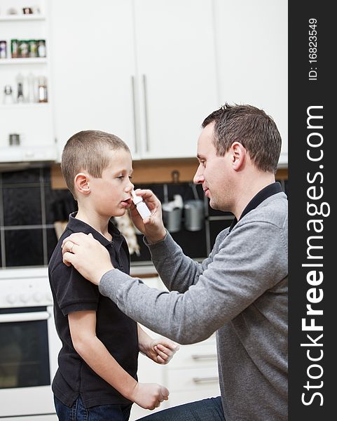 Father giving son Nose Drops