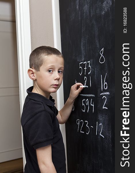 Young Boy in front of the blackboard. Young Boy in front of the blackboard
