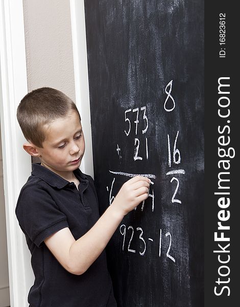 Young Boy in front of the blackboard