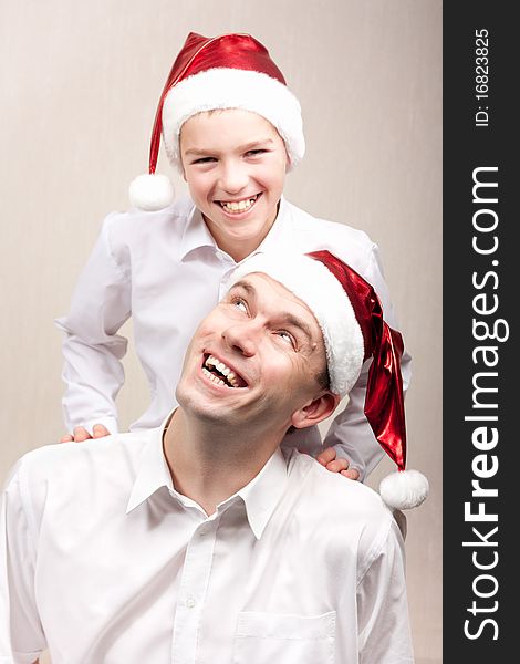 Happy and merry father and son in santa hat. Happy and merry father and son in santa hat