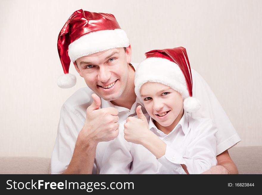 Happy and merry father and son in santa hat. Happy and merry father and son in santa hat