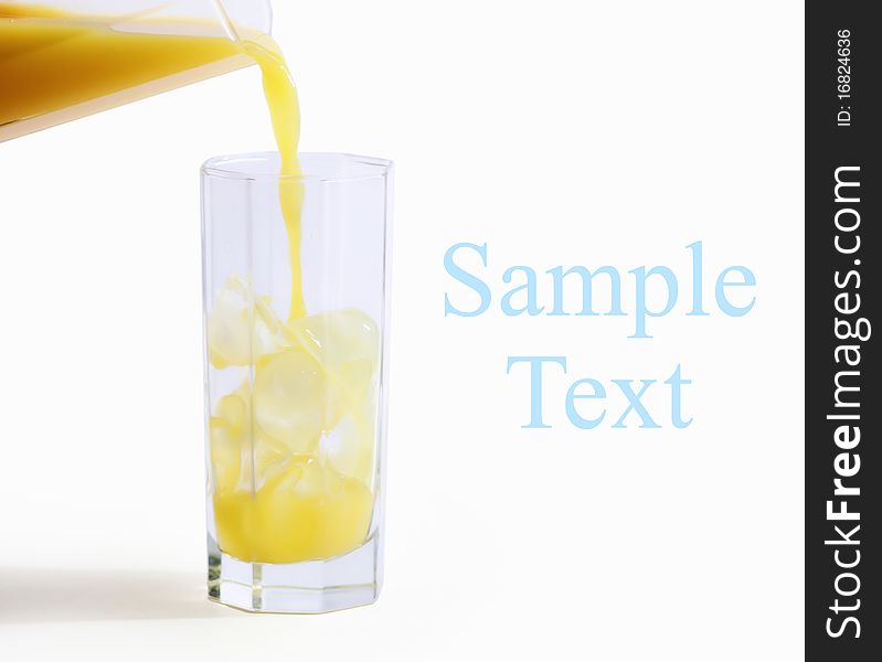 Orange juce pouring in a glass on white background with space for your text - hand made clipping path included. Orange juce pouring in a glass on white background with space for your text - hand made clipping path included