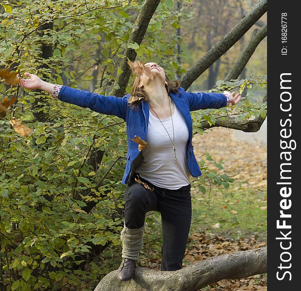 Woman in the autumn forest, playing with leaves. Woman in the autumn forest, playing with leaves