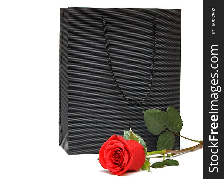 Black bag for a retail shopping experience with red rose. Black bag for a retail shopping experience with red rose