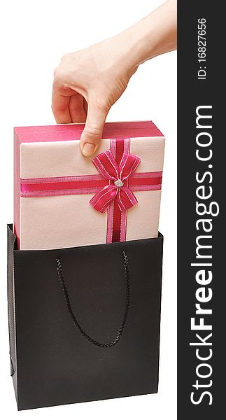 Female hand with beautiful gift box in white