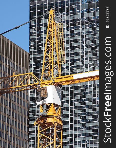 Construction site with a tall crane in city center.