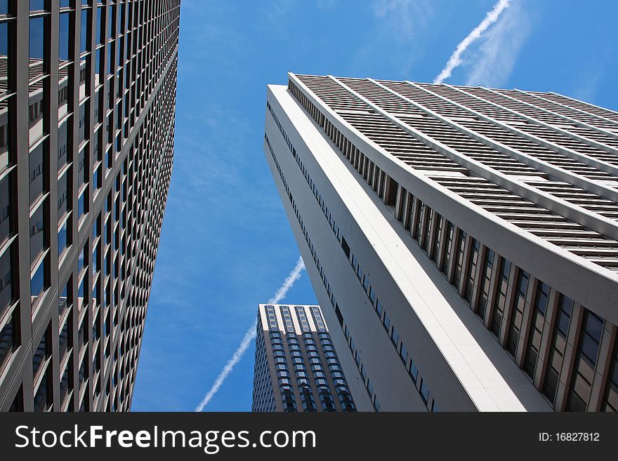 Looking up at tall skyscrapers in a downtown district