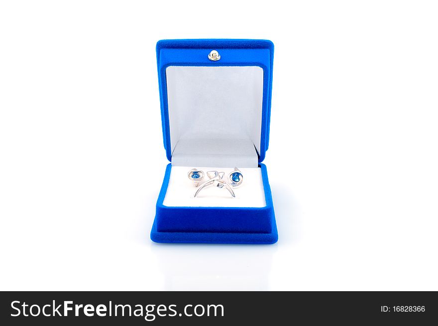 Luxury earrings in blue velvet jewelry box , isolated on white background