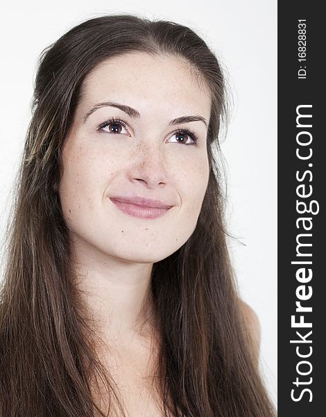 Portrait of beautiful young smiling girl with freckles, isolated on white background