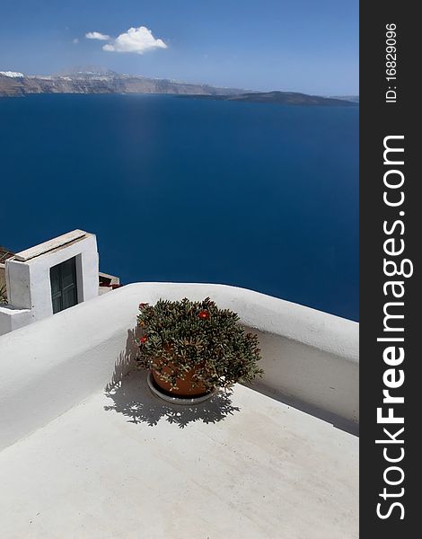 Sea view of the greece island from white terrace with flower pot. Sea view of the greece island from white terrace with flower pot