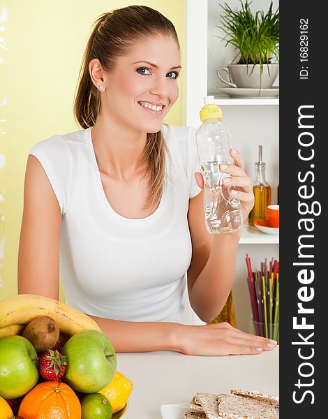 Beauty, young girl holding a bottle of water and smiling