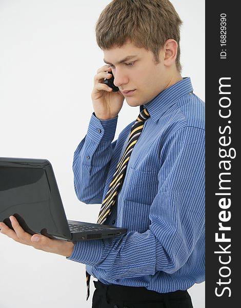Portrait of a young businessman with phone and notebook