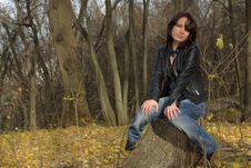 Girl Sitting On A Stump Royalty Free Stock Images