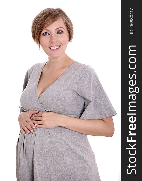Young pregnant woman in a studio setting isolated over white.