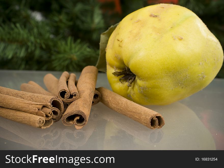 Cinnamon and apples on glass table