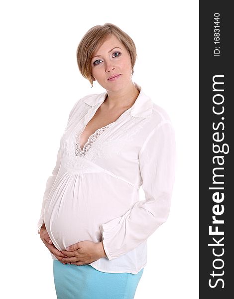 Young pregnant woman in a studio setting isolated over white.