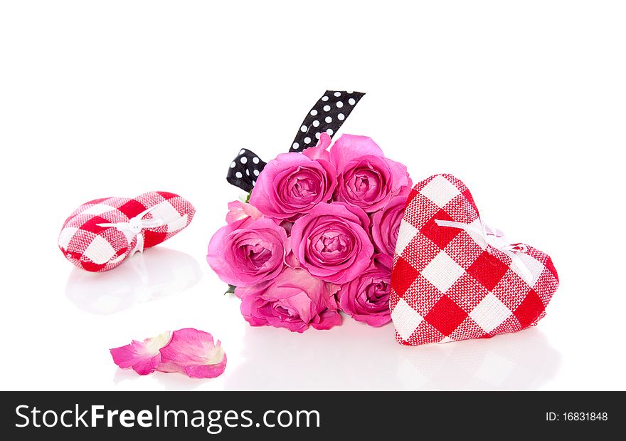 Pink roses and decorative checkered hearts isolated on white backgroun. Pink roses and decorative checkered hearts isolated on white backgroun