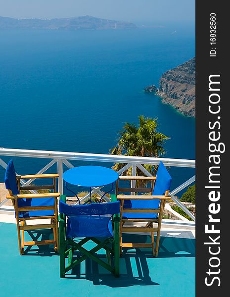 Blue chairs and table in Santorini