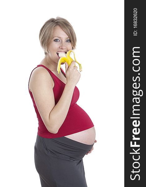 Photo of pregnant woman eating banana