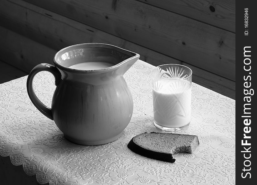 Still-life with milk jug, glass and rye bread. Still-life with milk jug, glass and rye bread