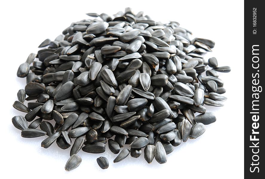 Small pile of sunflower seeds isolated on white background.