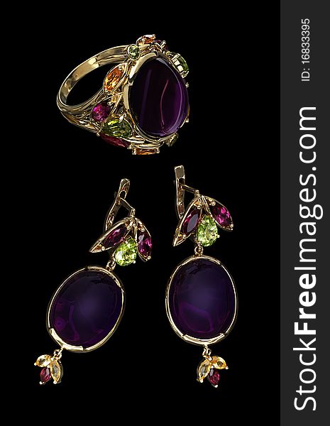 Set from a ring and 2 earrings isolated on a black background. Set from a ring and 2 earrings isolated on a black background