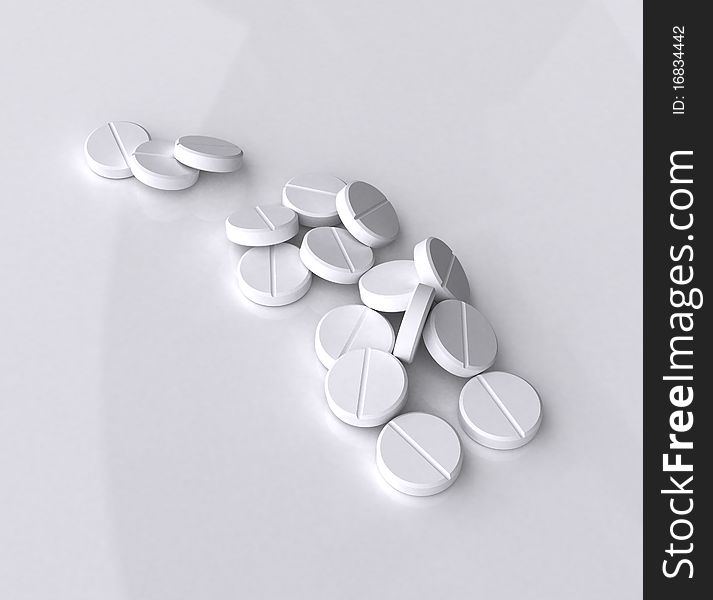 Handful of white tablets on gray